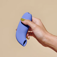 blue clitoral vibrator held in hand