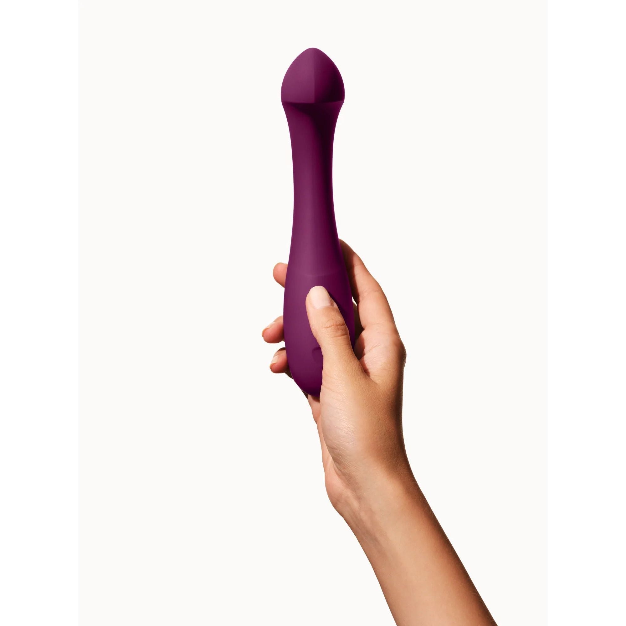 purple curved vibrator held in hand