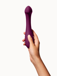 purple curved vibrator held in hand