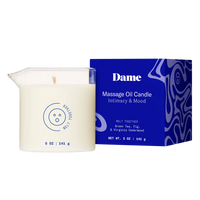 Massage oil candle with blue packaging labeled 'Dame' on a white background