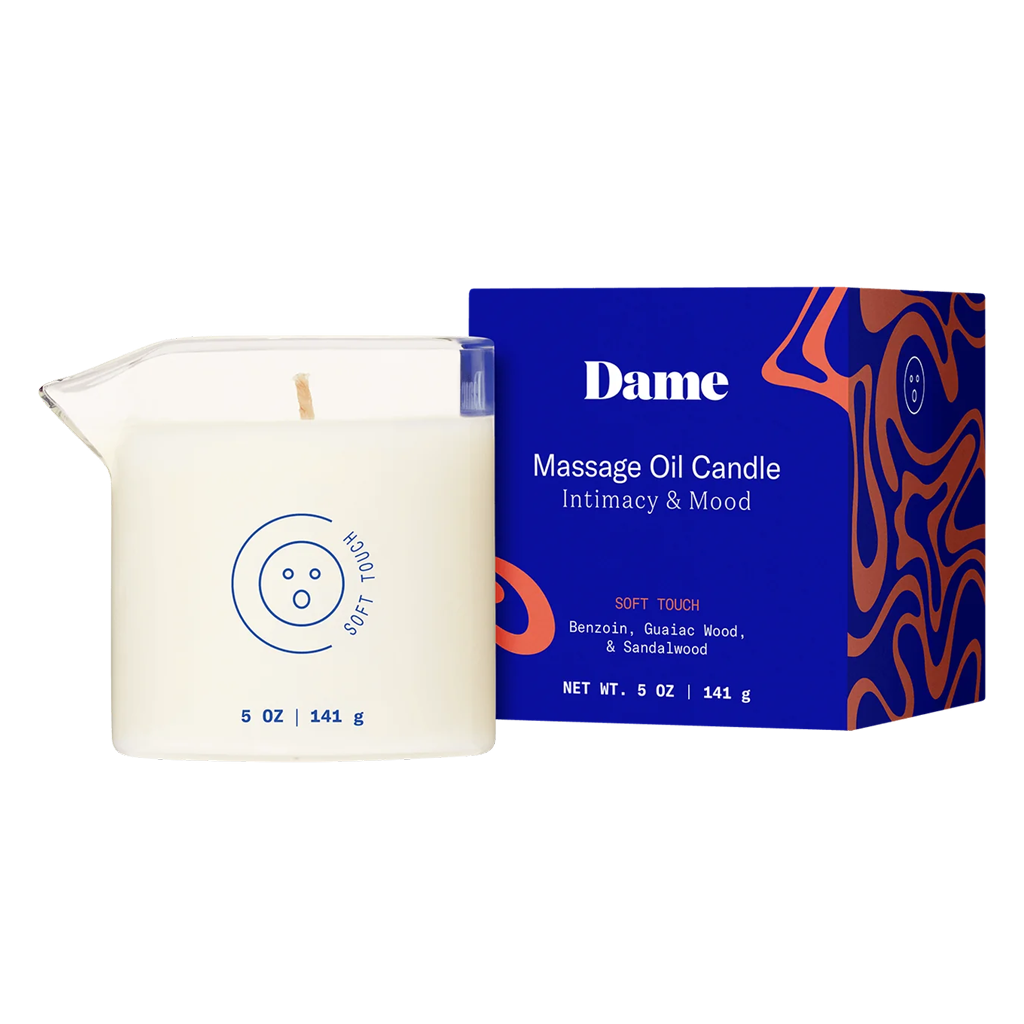 Massage oil candle with packaging labeled 'Dame' on a white background