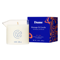 Massage oil candle with packaging labeled 'Dame' on a white background