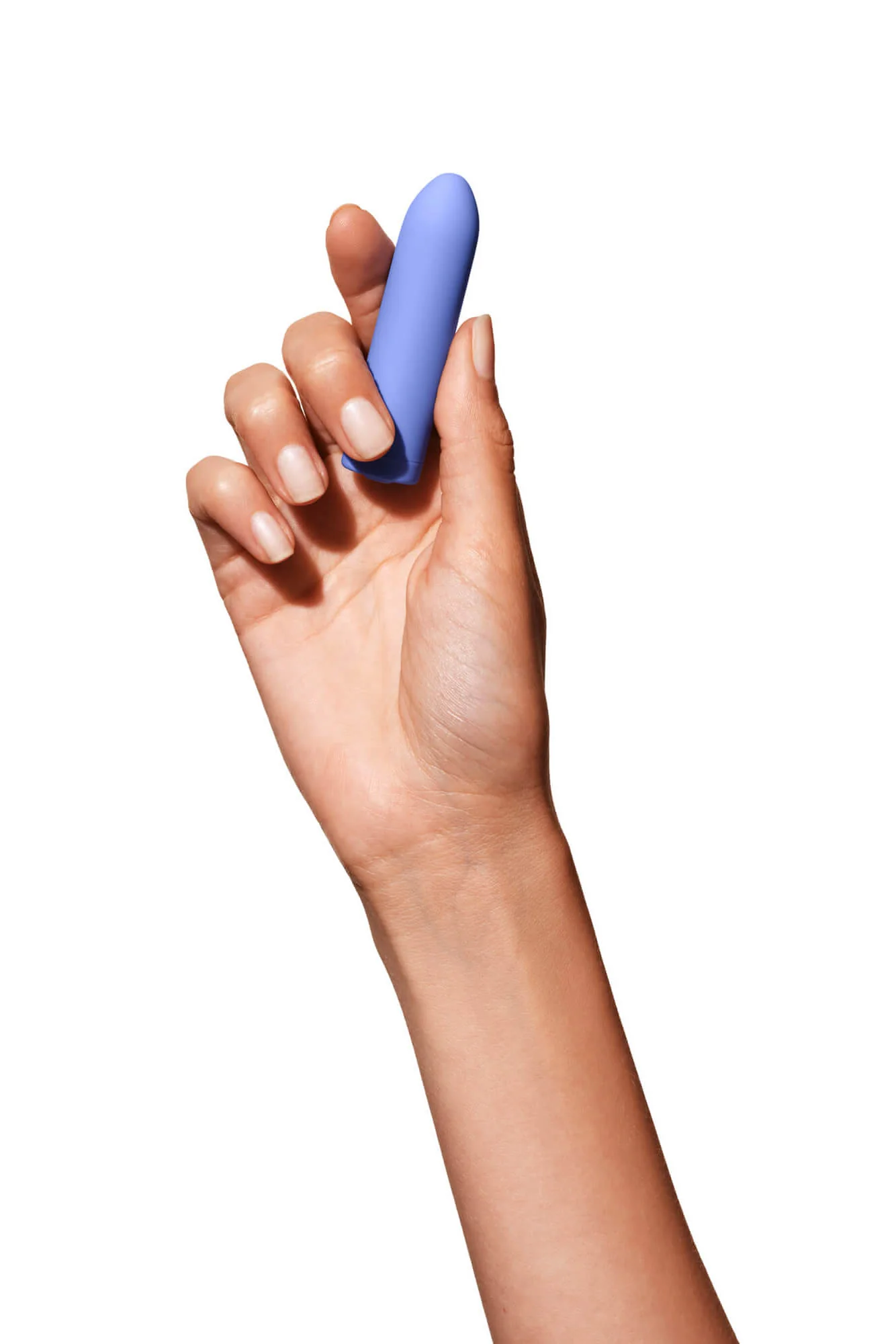Hand holding a blue vibrating bullet against a white background