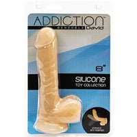 a beige detailed penis shaped dildo with balls and a suction cup, shown in its plastic packaging