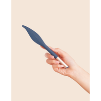 navy feather vibrator held in a hand