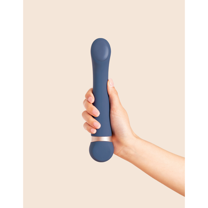 navy blue vibrator held in a hand