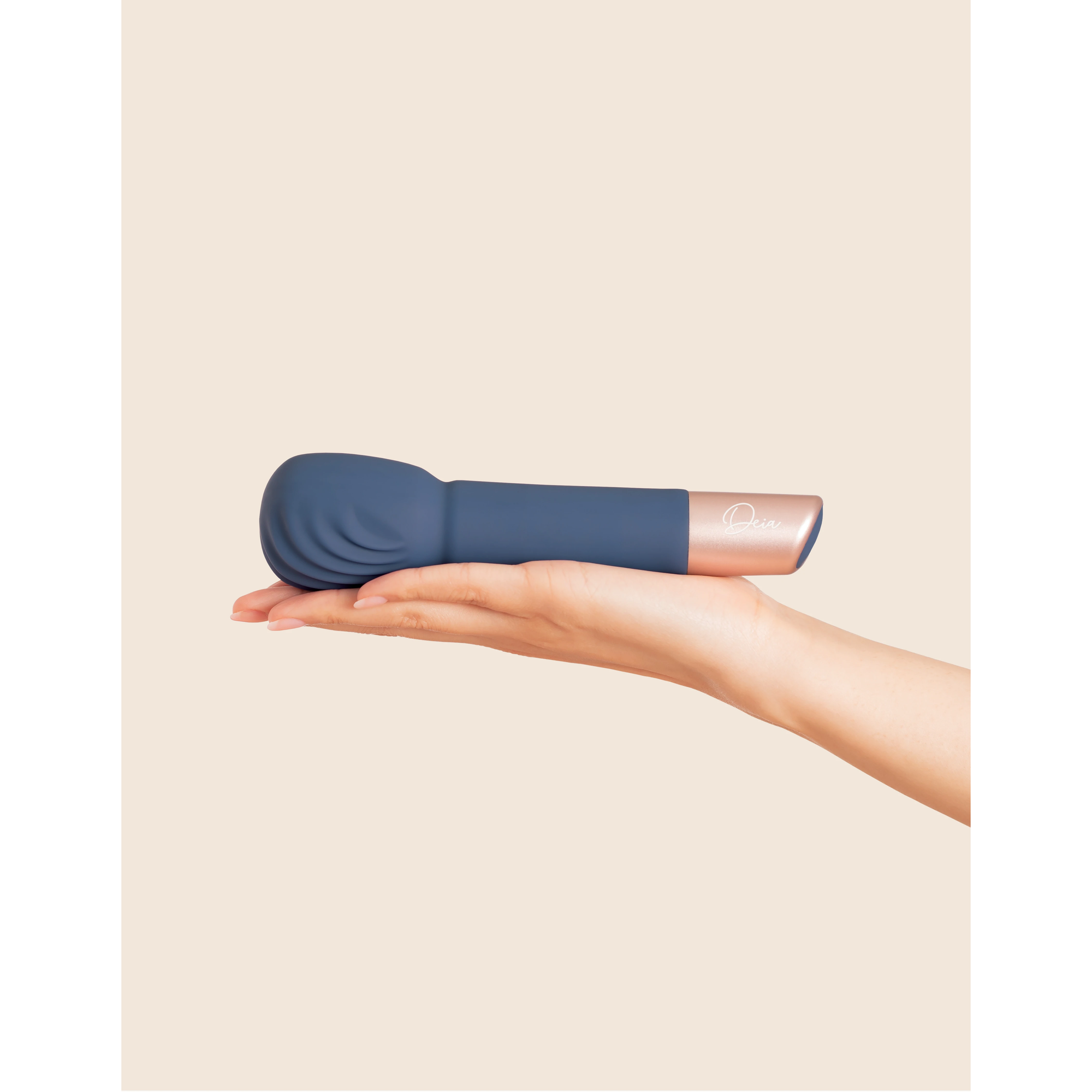 navy vibrating wand held on palm of a hand