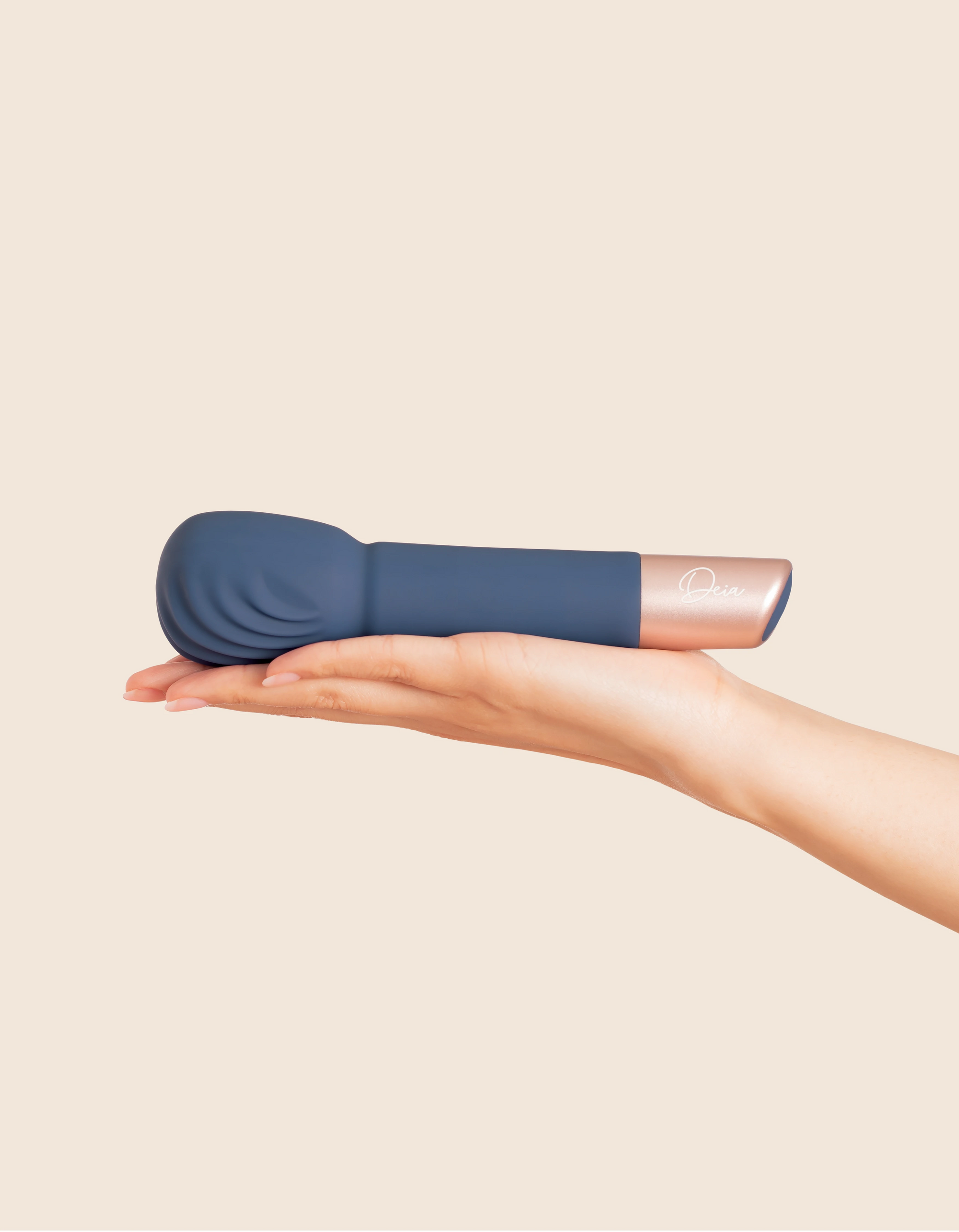 navy vibrating wand held on palm of a hand