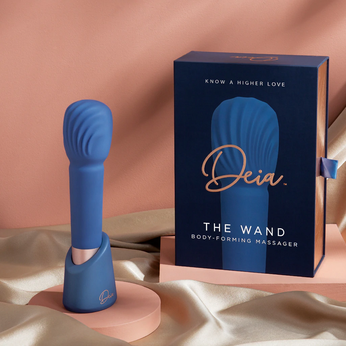 Blue body-forming massager with packaging on a beige background