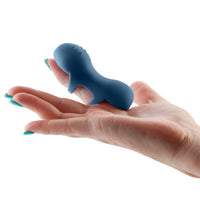 Blue vibrator on a hand against a white background