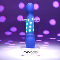 Blue and green disco diva vibrator with glowing polka dots on a purple background