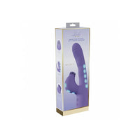 A boxed personal massager shown in its retail packaging on a plain white background. The box is predominantly white and lavender with gold trim and printed product imagery, including a purple curved device with blue light accents.