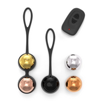 Set of black kegel balls with gold, silver, and bronze ends on a white background