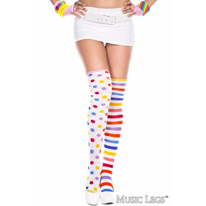 Colorful striped and polka dot knee-high socks worn by a person on a white background.