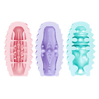 Three pastel-colored silicone masturbator eggs with textured designs on a white background