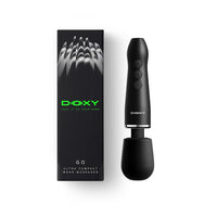 A black DOXY GO ultra compact wand massager shown next to its black packaging box with green branding, on a clean white background.
