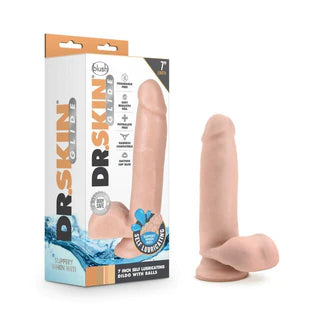 a beige detailed penis shaped dildo with balls and a suction cup, shown next to its white display box