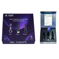 Dr. Tush's Dark Curiosity Collection unveiled dark desires anal plug and spiral set, shown with its purple packaging box and an open inner box displaying the products.