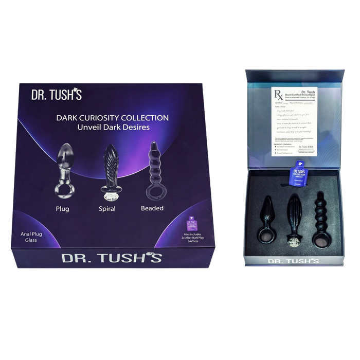 Dr. Tush's Dark Curiosity Collection unveiled dark desires anal plug and spiral set, shown with its purple packaging box and an open inner box displaying the products.