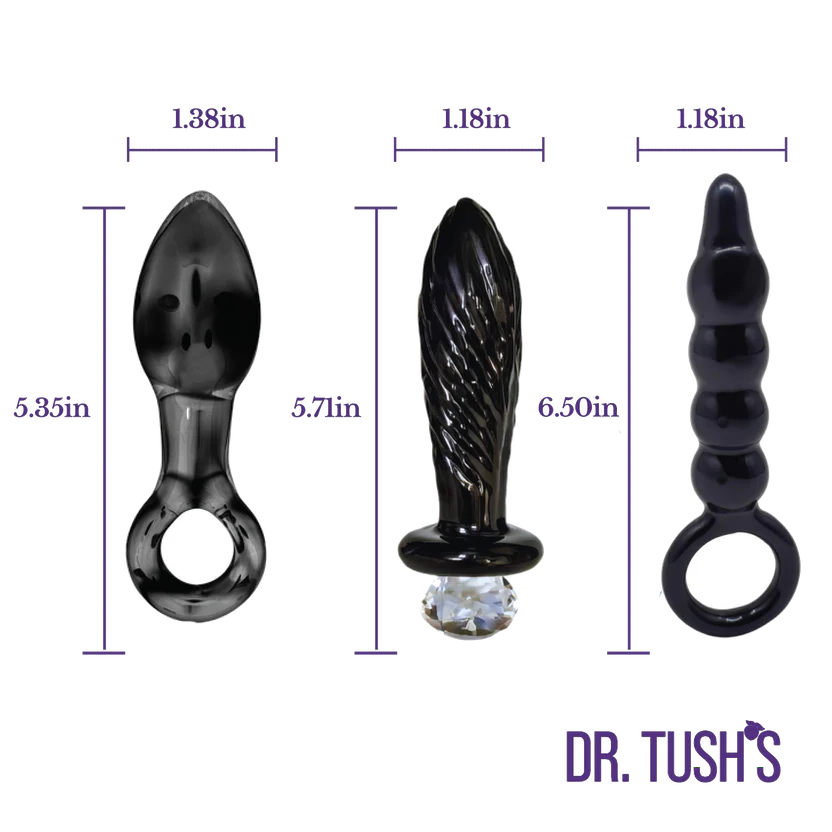 Three black adult novelty toys with dimension labels and purple measurement lines on a white background. The products include a curved glass piece, a textured cylindrical piece with a clear rhinestone at the base, and a ribbed curved piece with a ring.
