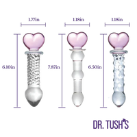 Three clear glass heart-shaped dildo shapes with dimension labels in purple text on a white background, with the brand name DR. TUSH'S at the bottom right.