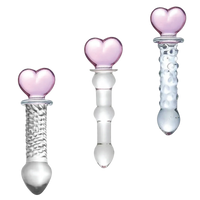 Three glass objects with heart-shaped ends on a white background