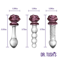 Three clear glass pelvic floor exercises beads with purple rose-shaped tops shown side by side with dimension labels and the brand name 'DR. TUSH'S' at the bottom right.