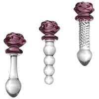 Three glass dildo accessories with purple and clear design on a white background