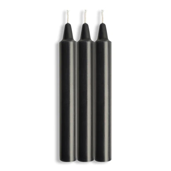 three black candles with white wicks