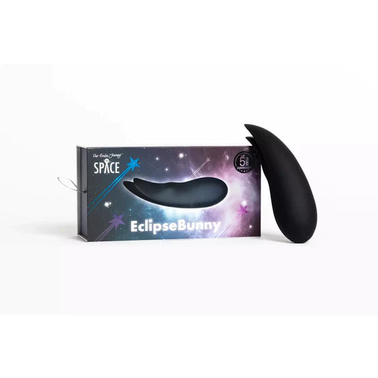 a black egg plant shaped vibrator with two flat tips. Shown next to a spaced theme box