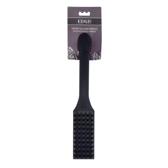 Black spiked silicone paddle with a handle on a white background
