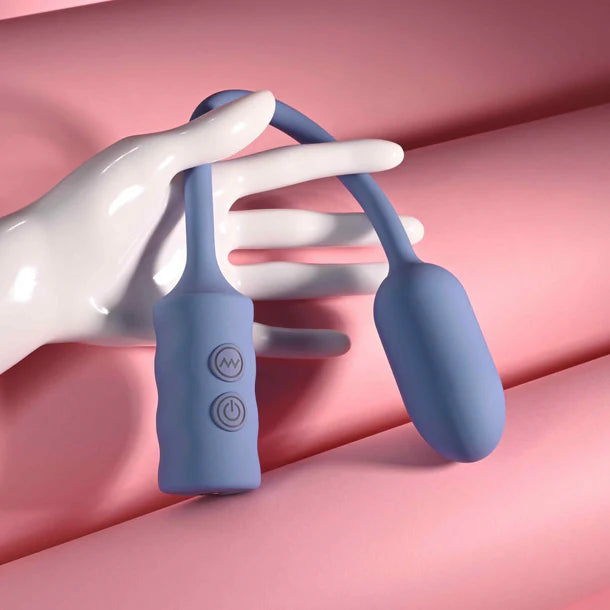 Blue handheld vibrating egg with a white hand on a pink background