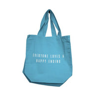 Blue tote bag with text 'Everyone loves a happy ending' on a white background