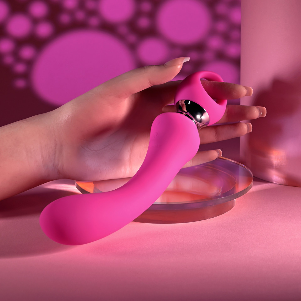 pink g-spot vibrator held in hand 