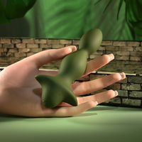 green ribbed anal plug held in hand