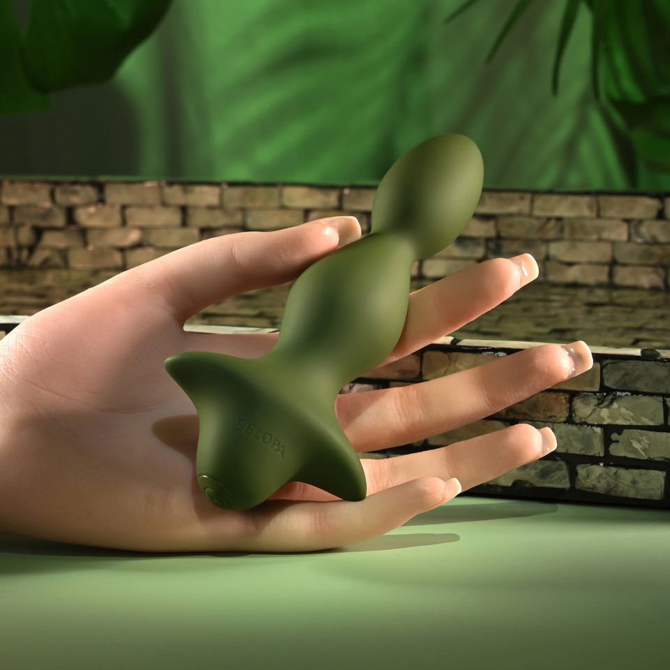 green ribbed anal plug held in hand