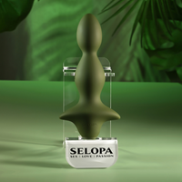 green ribbed anal plug, on stand on green background