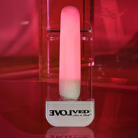 pink glowing vibrator on red background