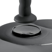 Close-up of a black dildo suction spot on and inflatable love seat a white background