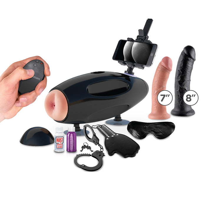 black sex mahcine with vaginal opening masturbator a tablet holder on top of machine, surrounded by 7" beige dildo, 8" black dildo a blindfold, hand paddle, black cuffs, moist anal lube, and purple bottle of refresh