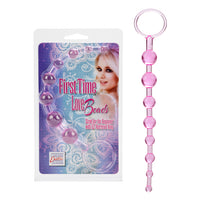 pink jelly anal beads with finger ring beside plastic package