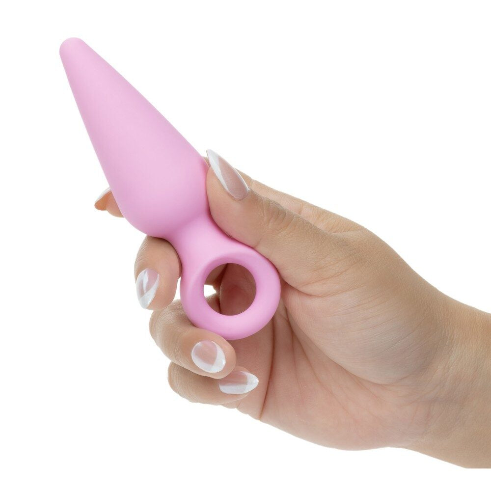 Hand holding a pink booty probe shaped object against a white background