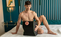 a male showing a fleshlight in the toy mount on a bed