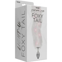 clear fox tail on silver anal plug on box cover