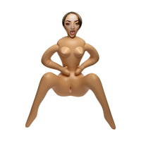 An inflatable adult novelty toy shaped like a seated nude female figure with a printed face, isolated on a white background.