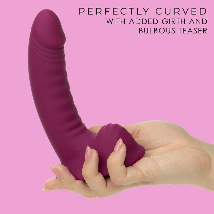 Purple g-ride vibrator held in a hand against a pink background with text describing its features.