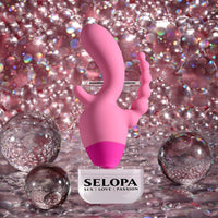 Pink vibrator with clitoral and and anal beads with 'SELOPA' branding on a glittery background