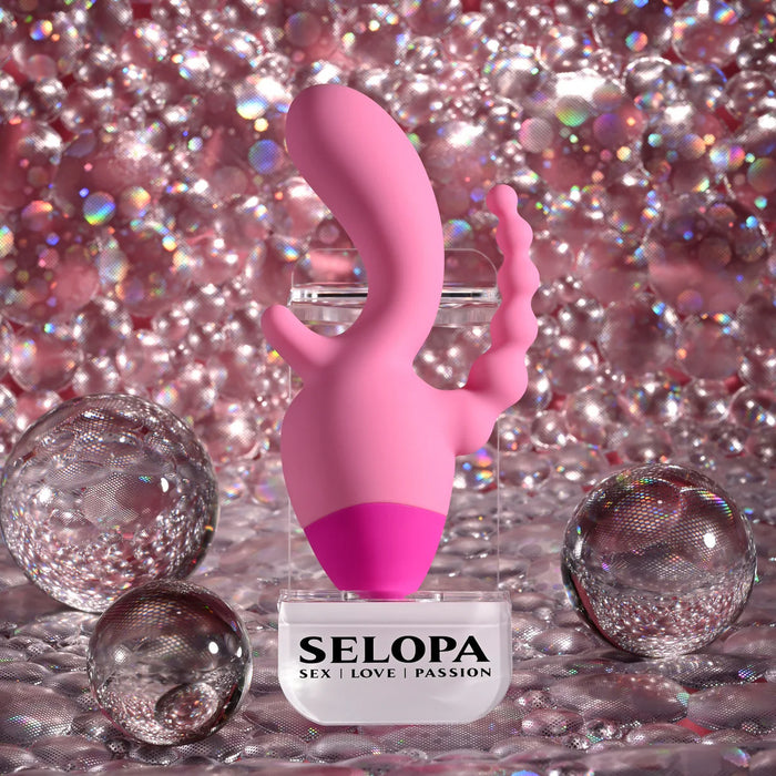Pink vibrator with clitoral and and anal beads with 'SELOPA' branding on a glittery background