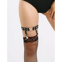 Black fishnet stockings with studded garter belt on a white background