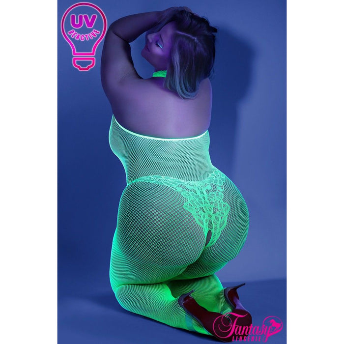 blond female on knees with green fishnet bodystocking back view